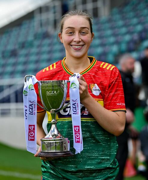 Captain Roisin Bailey celebrates with Carlow's newly won TG4 Leinster Ladies Football Junior Championship trophy. Photo: Ramsey Cardy/Sportsfile.