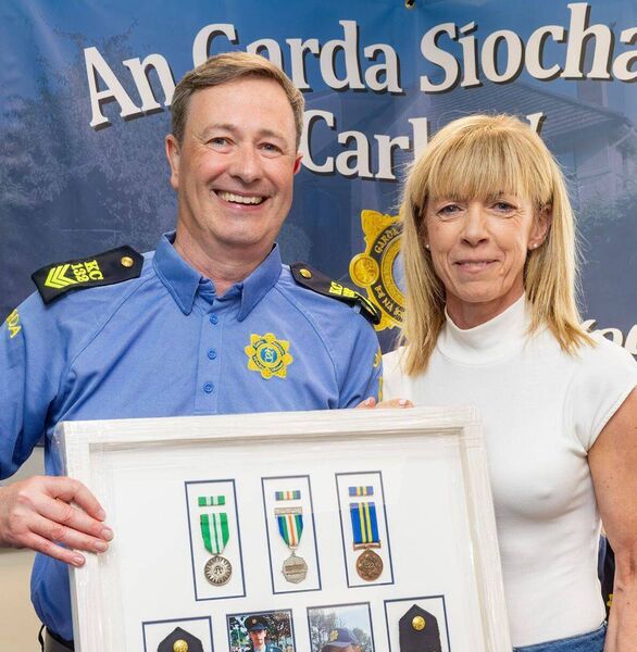 Garda Eileen Bergin on behalf of Carlow Community Engagement Social Club makes a presentation to Sergeant Egan Garda Eileen Bergin on behalf of Carlow Community Engagement Social Club makes a presentation to Sergeant Egan