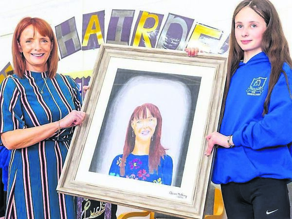 Alison McIlroy, on behalf of fifth and sixth class, presents a portrait she painted to retiring principal Nicola McGuill Alison McIlroy, on behalf of fifth and sixth class, presents a portrait she painted to retiring principal Nicola McGuill