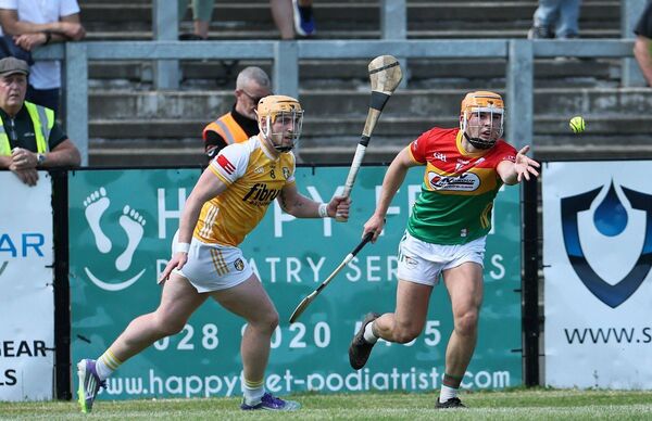 Jake Nolan gets his handpass away despite the attention of Antrim's Ryan McCambridge. Jake Nolan gets his handpass away despite the attention of Antrim's Ryan McCambridge.