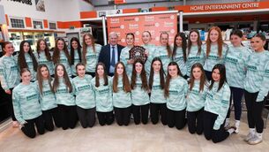 <p>Carlow Camogie Sponosor Sean Swan with the All-Ireland winning U16 team and their trophy.</p>