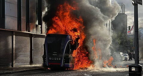 Bus set alight by masked protesters as violence flares following stabbing attack