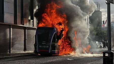 Bus set alight by masked protesters as violence flares following stabbing attack