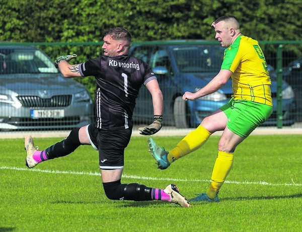 Crettyard’s Lee Salter puts his team a goal up as he fires past Bagenalstown goalkeeper Derek Tebay. Photos: © Michael O’Rourke Photography
