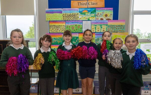 Some third class pupils pictured in front of their paintings 