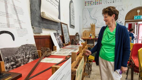 Brigid Fox looks over some of the ancient artefacts during the St Moling's Day celebrations in the St Mullins Heritage Centre