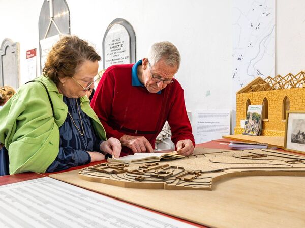 Helen and Thomas Brennan look over a cemetery genealogy book in the St Mullins Heritage Centre