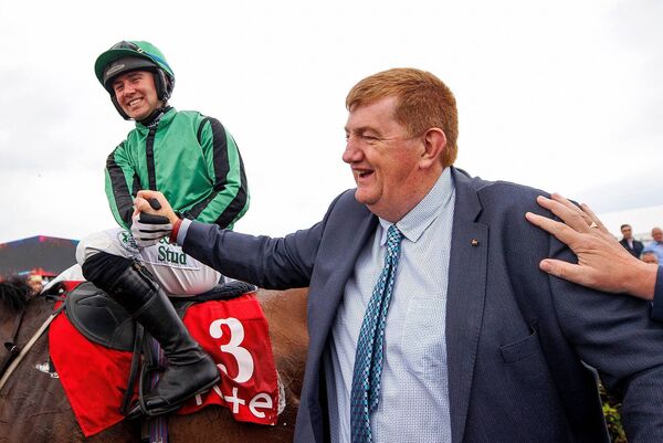 ordan Gainford celebrates with trainer John ‘Shark’ Hanlon after with won the Galway Plate with Hewick in 2022 Photo: ©INPHO/James Crombie