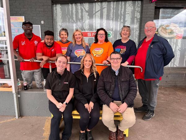 Members of Tullow Men's Shed and Carlow Mental Health Association with their 'buddy bench' in Tullow
