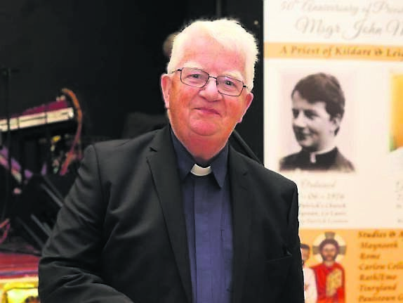 Mgr John McEvoy cuts the party cake