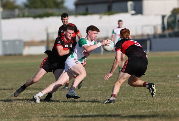 Palatine's Mark Buggy weaves in between MLR's Jamie Nolan with Conaill Fitzpatrick.