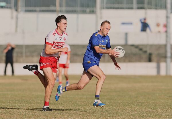 St Patrick's sharpshooter Jack Kennedy is chased down by Ballon's Evan Corr.