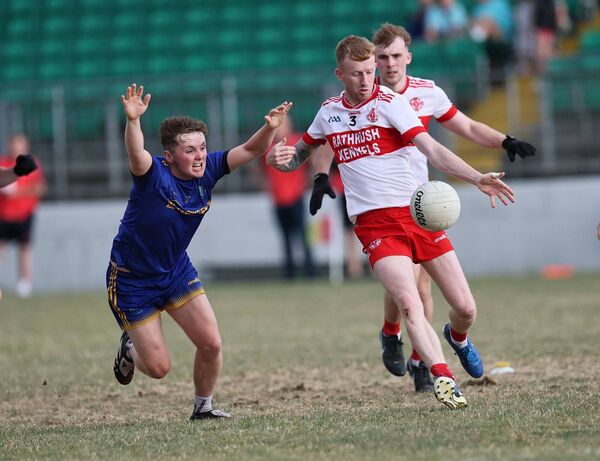 Ballon's Dan O'Connor clears his lines with St Patrick's Jack O'Neill diving to block.