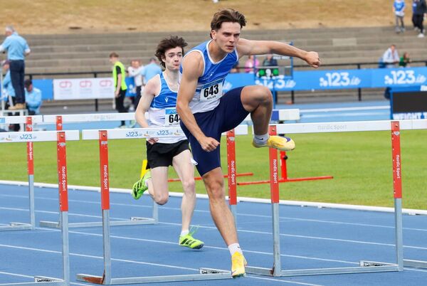 Adam Nolan leads Ruben McCarthy during the 110m hurdles final.