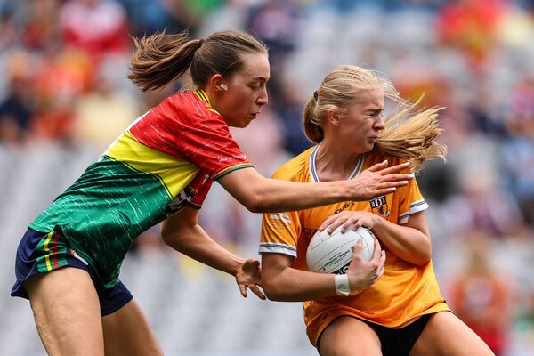 Carlow captain Róisín Bailey tackles Antims Aioibhann Monaghan. Photo: INPHO/Ben Brady