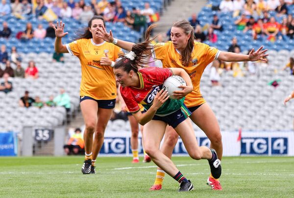 Carlow's Brónagh Nolan comesunder pressure from Antrim's Dúana Coleman.
