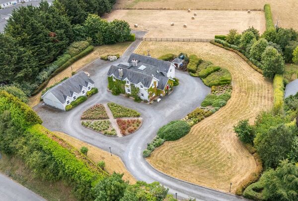 An aerial shot of the home in Rathvinden sitting in 2.7 acres of mature landscaped gardens.