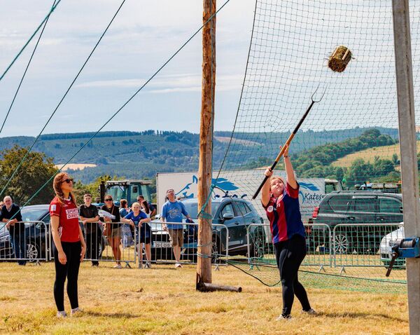 Rebecca Casey looks on as Holly Armstrong takes part in the sheaf throwing competition Rebecca Casey looks on as Holly Armstrong takes part in the sheaf throwing competition