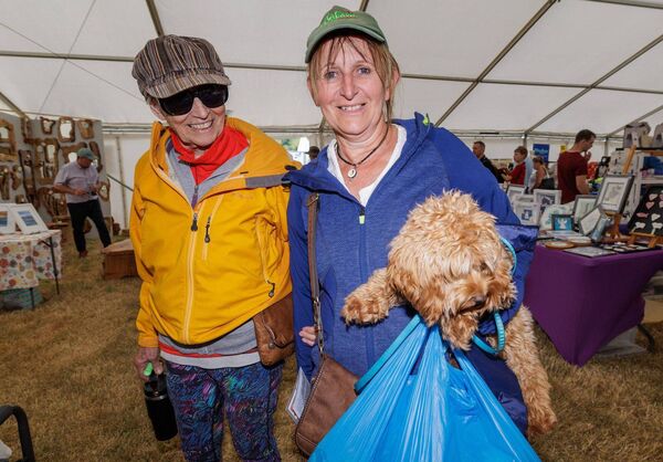 Laura and Jean Bader with their dog Zulu in the crafts tent Laura and Jean Bader with their dog Zulu in the crafts tent