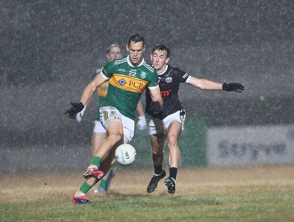 Fenagh's Ciaran Whelan gets in his tackle on Rathvilly's Brendan Murphy as the rain lashes down. Fenagh's Ciaran Whelan gets in his tackle on Rathvilly's Brendan Murphy as the rain lashes down.