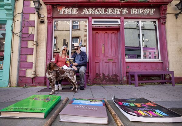 Sheila and Andy Morby, with their dog Otto, read one of the many books around the town of Graignamanagh during the Town of Books Festival Photo: Finbarr O'Rourke Sheila and Andy Morby, with their dog Otto, read one of the many books around the town of Graignamanagh during the Town of Books Festival Photo: Finbarr O'Rourke