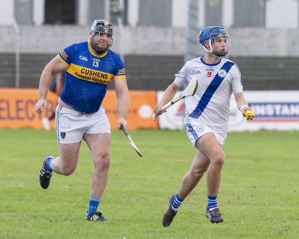 Ballinkillen's Conor Treacy tries to hook Carlow Town's Harry Delaney. Ballinkillen's Conor Treacy tries to hook Carlow Town's Harry Delaney.