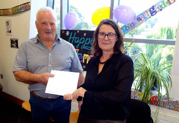 Claire Hartley, director of services presents Christy with a gift from his colleagues Photos: Paul Curran 