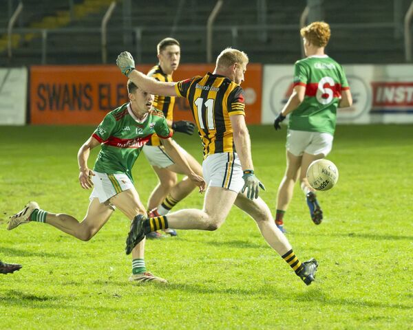 Naomh Eoin's Adam Kenny fires a shot towards the Ballon posts.