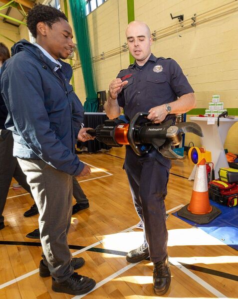 Ronan Doyle from Carlow County Fire and Rescue Service demonstrates a cutting machine with Daniel Da Silva from St Mary's Academy Ronan Doyle from Carlow County Fire and Rescue Service demonstrates a cutting machine with Daniel Da Silva from St Mary's Academy