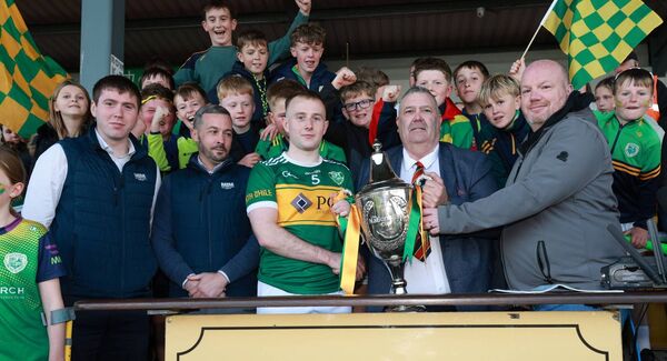 Ger McNally (Sports Editor of The Nationalist) and John McDonald (County Board chairman) present Rathvilly captain Colin Byrne with The Nationalist Cup. Photo: Pat Ahern