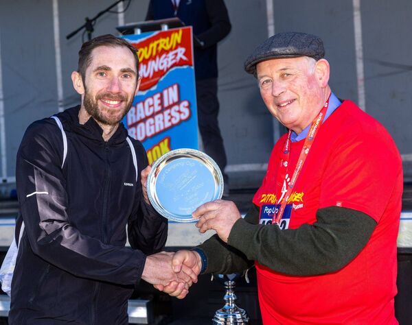 Fr John Dunphy presents Ian Molloy with first place overall in the 5k race Fr John Dunphy presents Ian Molloy with first place overall in the 5k race