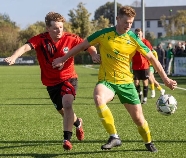 Crettyard’s Jonah Kelly holds off New Oak’s Jack O’Neill.