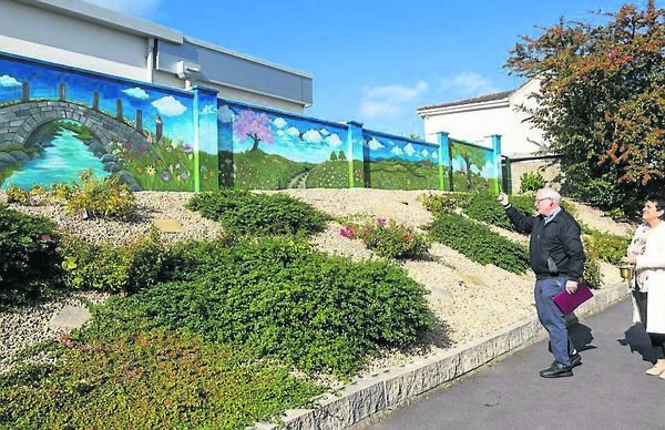 Fr John Dunphy blessing the mural with manager, Joan Doogue Fr John Dunphy blessing the mural with manager, Joan Doogue