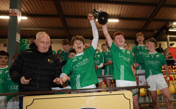 Nicky Parle presents the CENTAL U 16 Div 1B trophy to St Mullins joint captains Dylan King and Charlie Foley