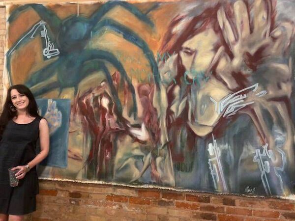 Maeve Holmes with her main artwork for the FLARE exhibition